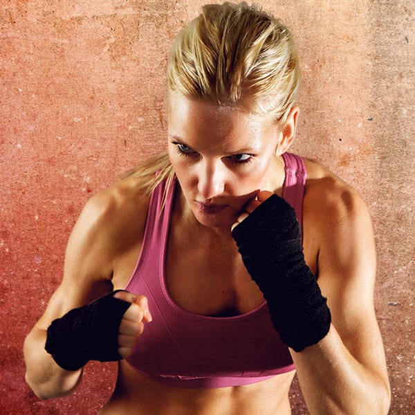 Mixed Martial Arts Lessons for Adults in Chandler AZ - Lady Kickboxing Focused Background